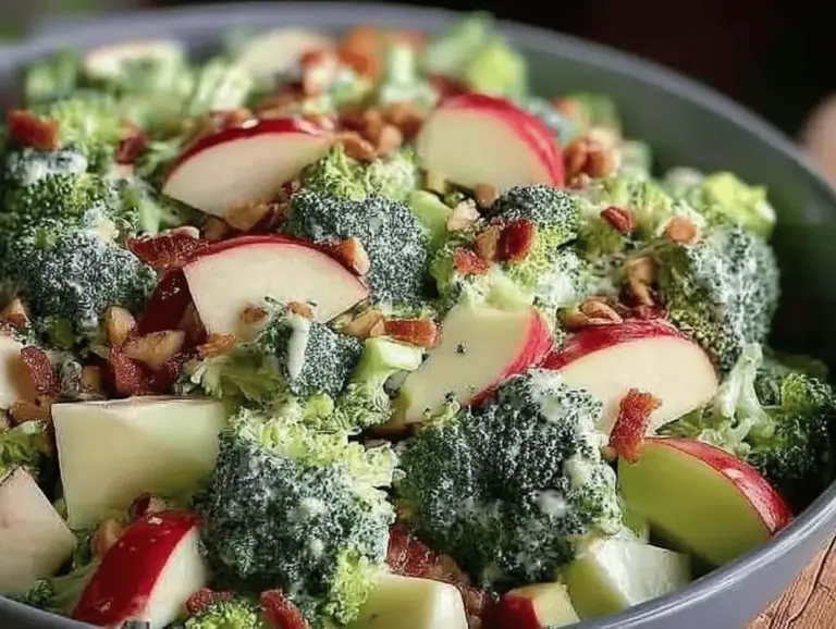 Healthy Honeycrisp apple broccoli salad with walnuts and cranberries in a decorative bowl.