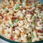 Guy Fieri's Mac-Daddi-Roni Salad with colorful vegetables and fresh herbs in a bowl, ideal for summer barbecues.