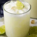 Refreshing Brazilian lemonade with mint and lime slices in a glass, perfect summer drink